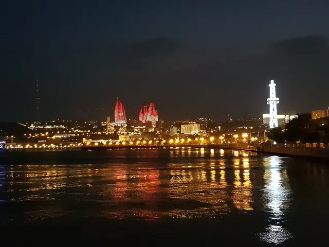 The Flame Towers lit red above the Baku waterfront at night