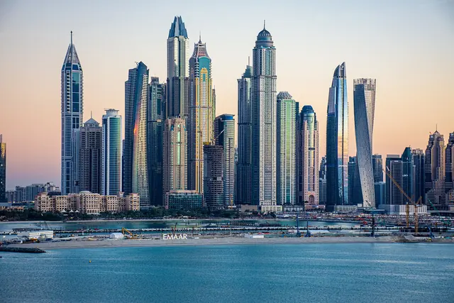 Towers of Dubai Marina along the waterfront at dusk