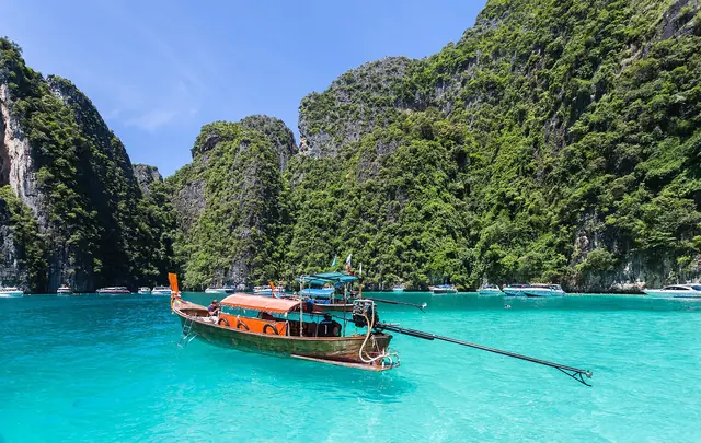 Longtail boats in the turquoise lagoon of Phi Phi Leh, ringed by limestone cliffs