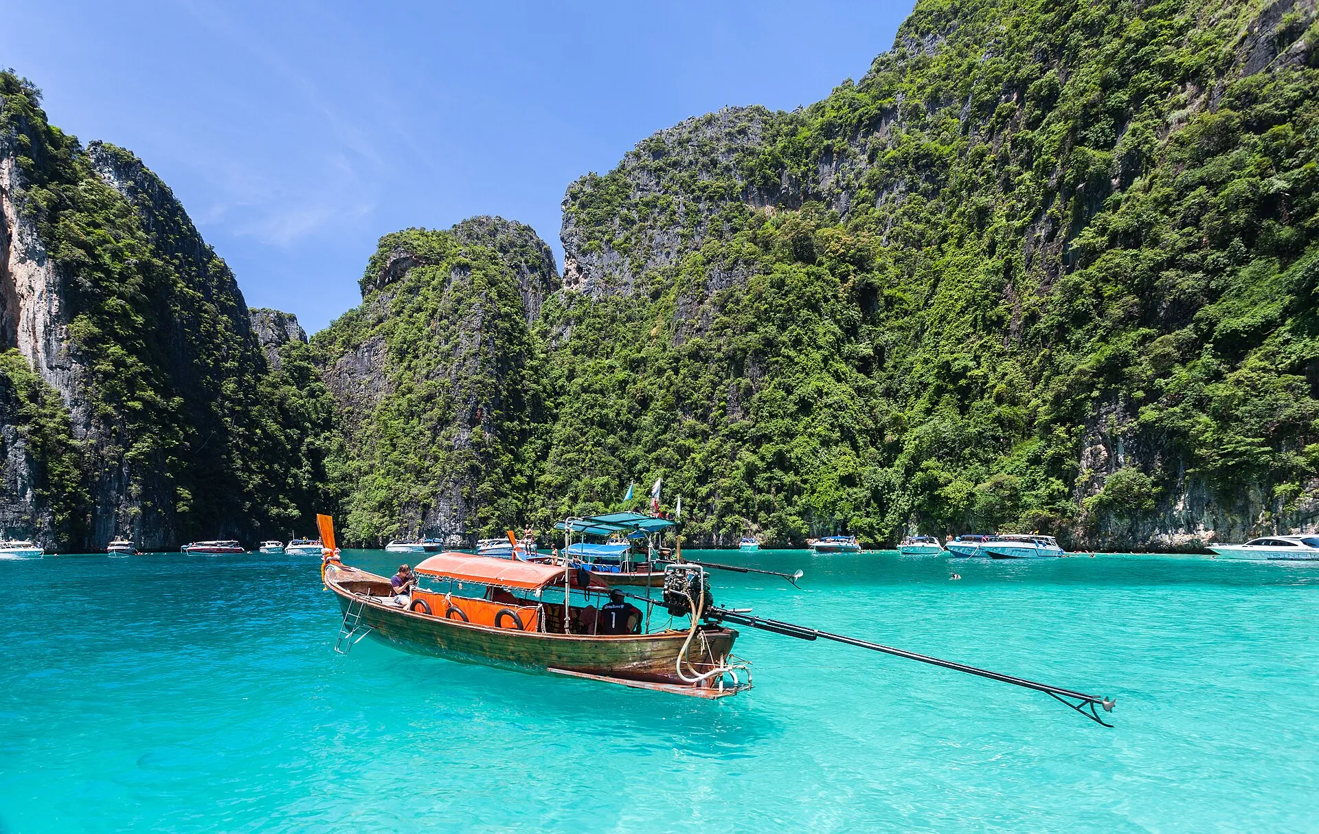 Longtail boats in the turquoise lagoon of Phi Phi Leh, ringed by limestone cliffs