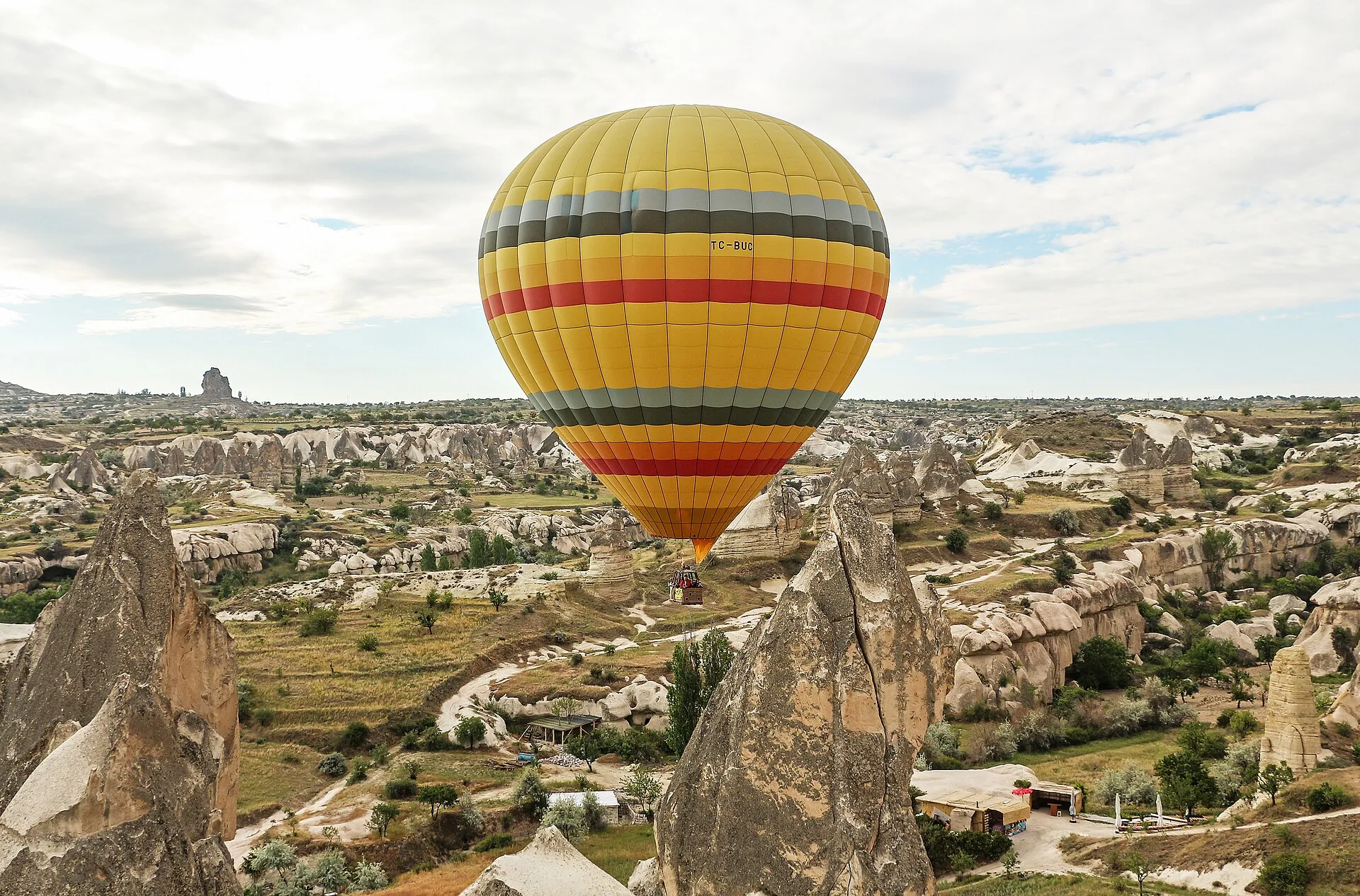 A hot air balloon floating over the valleys of Cappadocia
