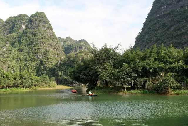 Boats on the river among karst hills at Trang An, Ninh Binh